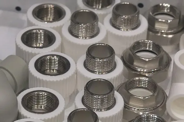Metal threaded inserts molded into white plastic parts
