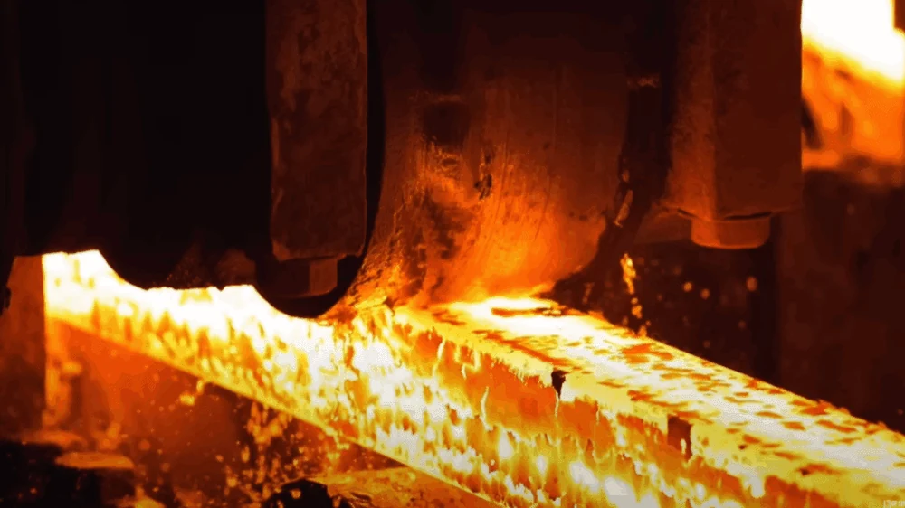 Stainless steel slab being rolled while still red hot