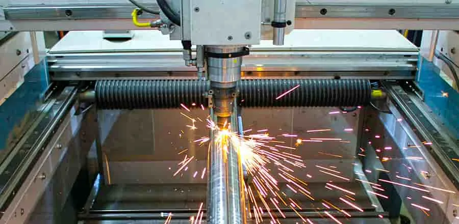 Fibre laser cutting head piercing a stainless steel tube on a tube laser machine