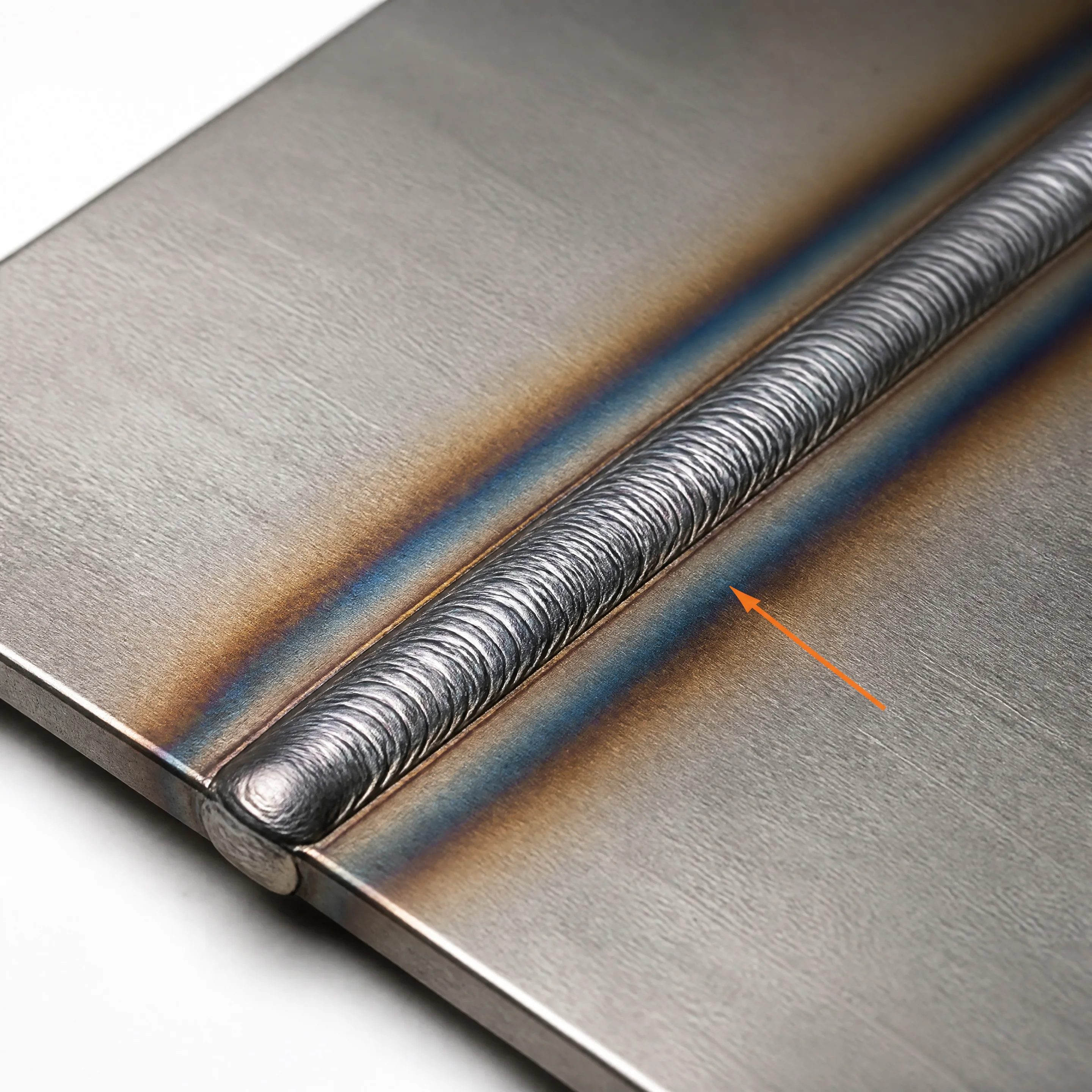 TIG weld seam on lapped cold-rolled steel with visible heat-affected zone discoloration