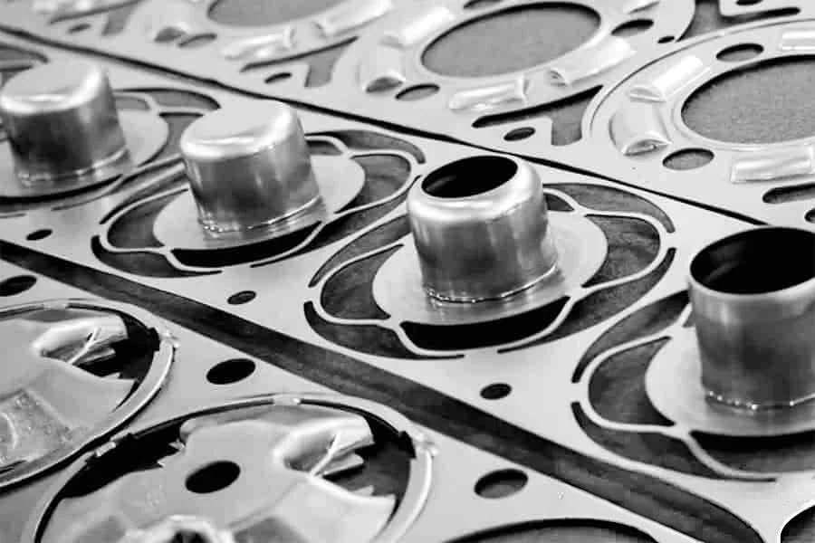 Close-up of formed bosses and flanges in a stamped strip